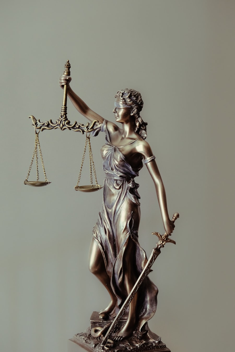 A bronze statue of Lady Justice holding the scales